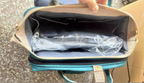 Diaper bag backpack — worn by a parent for hands-free use during outings