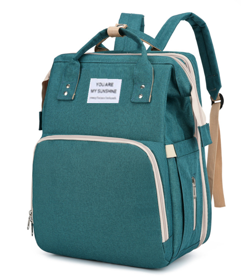 Diaper bag backpack — side view showing exterior pockets and grab handle